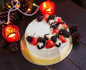 Christmas cake with strowsberry raspberry chocolate and lights bokeh homemade bakery 