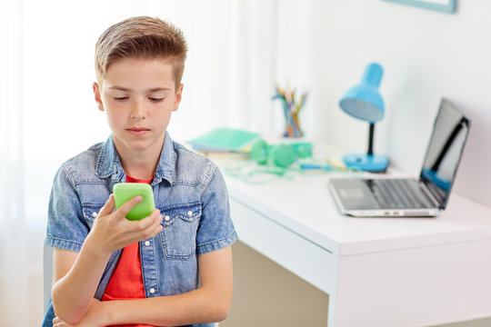 boy with smartphone being bullied by text message