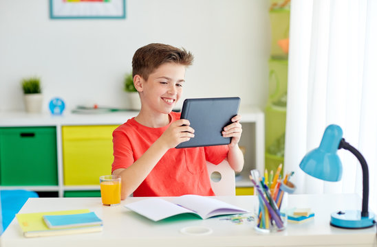 Student Boy With Tablet Pc And Notebook At Home