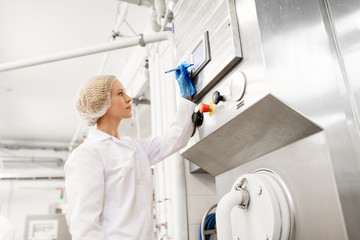 woman programming computer at ice cream factory