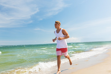 Fototapeta na wymiar happy man running along summer beach