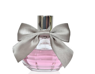 Female perfume in bottle with bow isolated on white background
