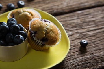 Blueberries and muffins on plate