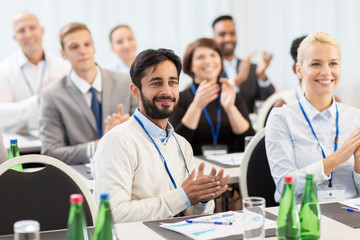 people applauding at business conference