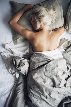 Beautiful Blonde Woman Sleeping in Bed