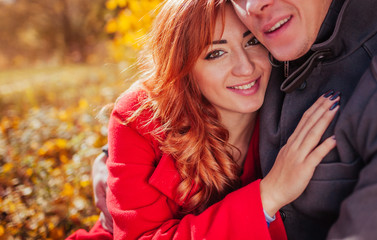 Young couple hugs in autumn forest
