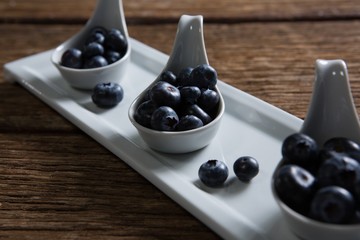 Blueberries in spoon arranged on tray