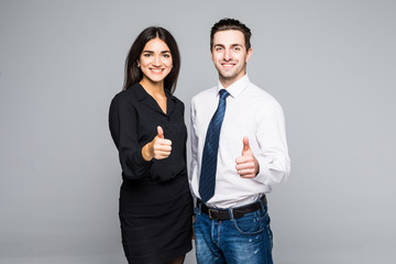 Business people who have their thumbs up on gray background