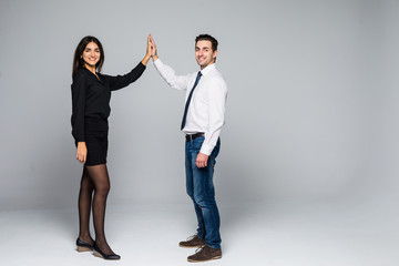 Enthusiastic business partners giving each other a high five. Isolated on white.