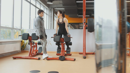 Athlete man and woman have conversation in the gym