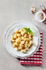Italian gnocchi in a plate with tomato sauce.