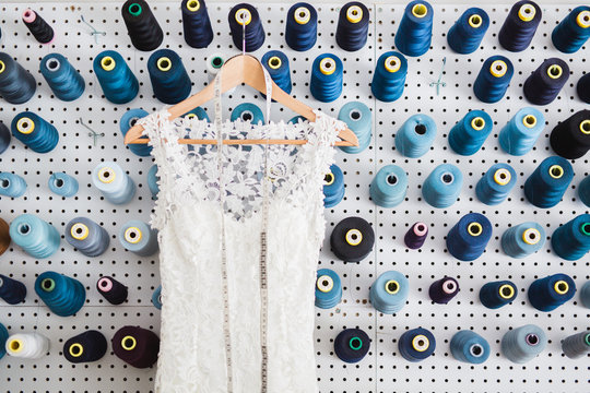 hand maid wedding dress in front in the workshop