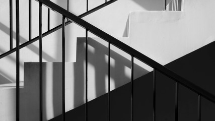 Modern metal railing at staircase with shadow in a modern concrete building