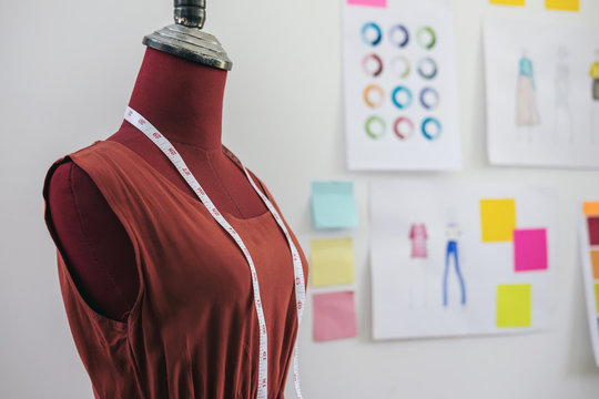 Red dummy with measuring tape in tailors studio, Creative Design and Artistic Concept