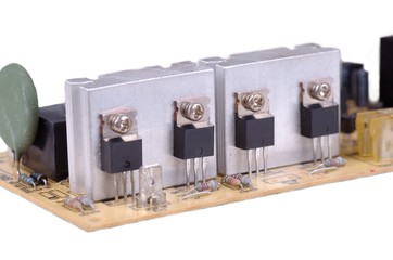 Group of transistor on circuit board of uninterruptible power supply.