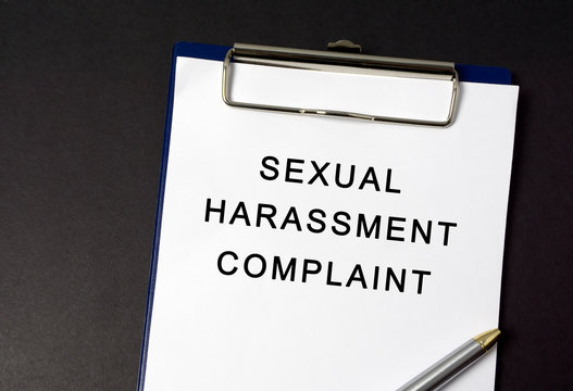Sexual Harassment Complaint Word On Paper, Black Background
