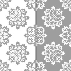 White and gray floral backgrounds. Set of seamless patterns