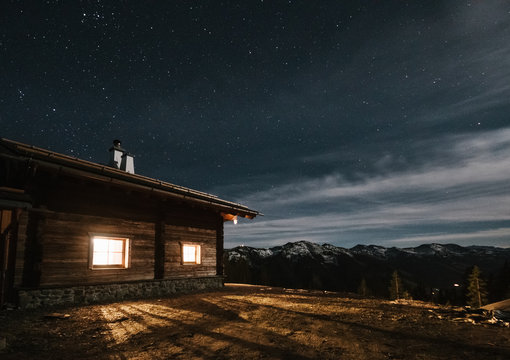 alpine cabin at night in the mountains