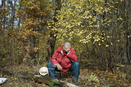 пожилой одинокий мужчина в осеннем лесу