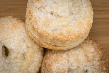 Three Apple Puff Pastries on decorative chopping board