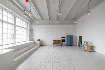Interior with vintage furniture, light studio with old bench and blue case. Spacious studio with a...