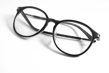 Old glasses on broken legs on white background,selective focus
