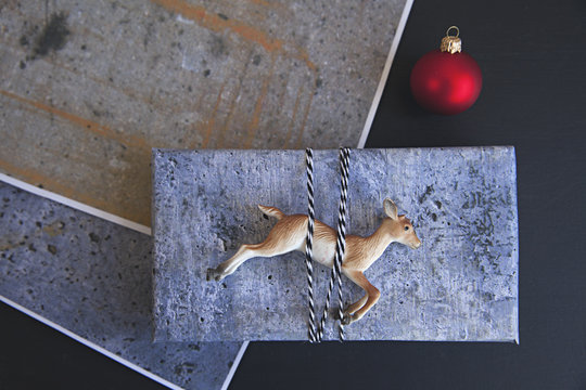 handmade / DIY concrete style gift wrap for Christmas on black background