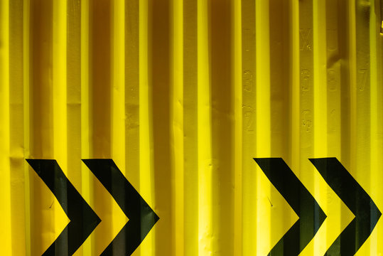 Black Arrows on Yellow Cargo Container