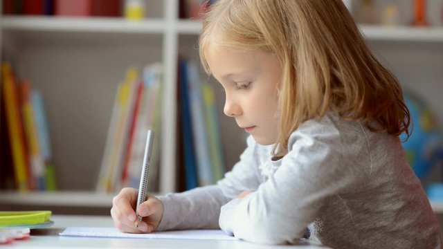 Portrait of ute little girl learning in school