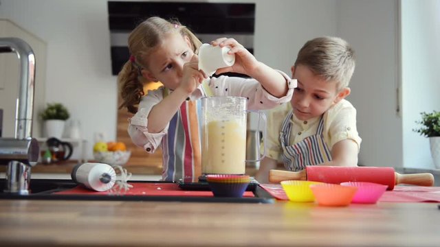 Two cute children having fun during preparation christmas cookies