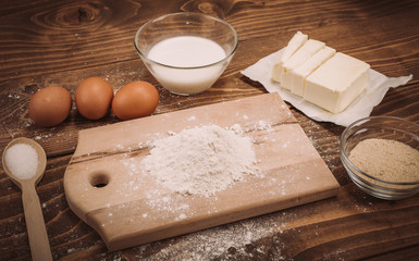 Dough recipe ingredients on vintage rural wood kitchen board