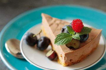  chocolate cheesecake with fresh blueberry and mint close up