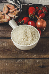 rice raw on wooden soil as well as onions, carrots and other