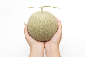 Close up hands hold melon on white isolated background