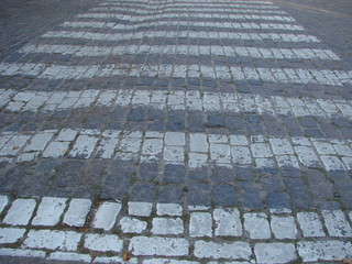 crosswalk on the road for safety when people walking cross the street.