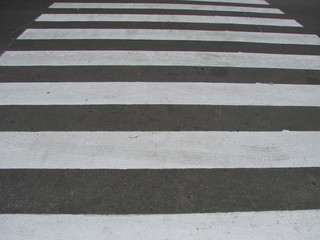 crosswalk on the road for safety when people walking cross the street.