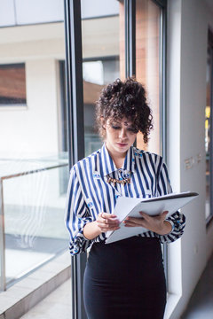 Young bussineswoman checking paperwork.