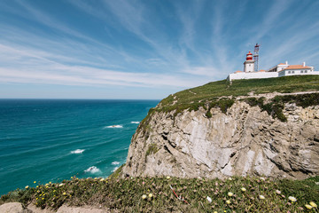 Fototapeta na wymiar Lighthouse on Cabo da Roca cape in Sintra, Portugal, summer day with a view on the Atlantic ocean
