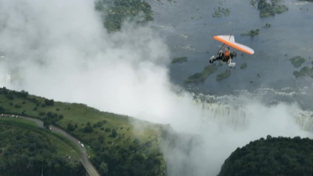 Aerial view of microlight aircraft flying above Victoria Falls and Zambezi river