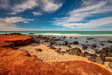 Maui Red Dirt at Baby Beach. Very colorful scene with the red dirt, gold beach, black lava rocks,...