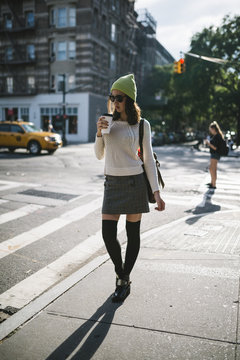 Young woman with a coffee cup in Manhattan streets