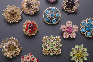 set of brooches isolated on black. background of many brooches