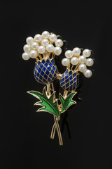 brooch flowers with pearls isolated on black