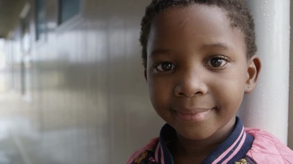 Little girl from South African community looking at the camera & smiling