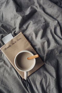 Book and Hot Coffee on Bed