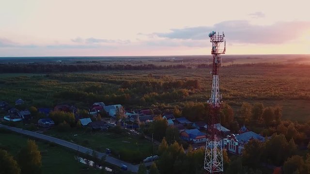 Silhouette telecommunications antenna for mobile phone at sunset