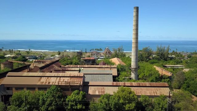 Aerial Kekaha Waimea Kauai Hawaii old sugar mill ocean. Old abandoned and derelict. Rusty building and equipment. Garden Isle. Economy is now tourism based.