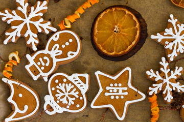 christmas gingerbread homemade cookies with oranges on cooking paper