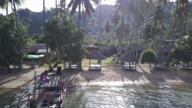 Backpacker tourists board a fisherman&rsquo;s boat as they prepare to go snorkeling in the waters around Koh Tonsay, Rabbit Island.