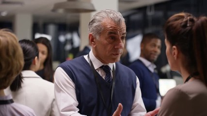  Diverse business group talking and networking at a business conference